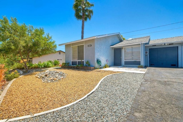 4549 Quailridge Dr, Oceanside, CA 92056 - mid-century home with stucco siding, an attached garage, and asphalt driveway