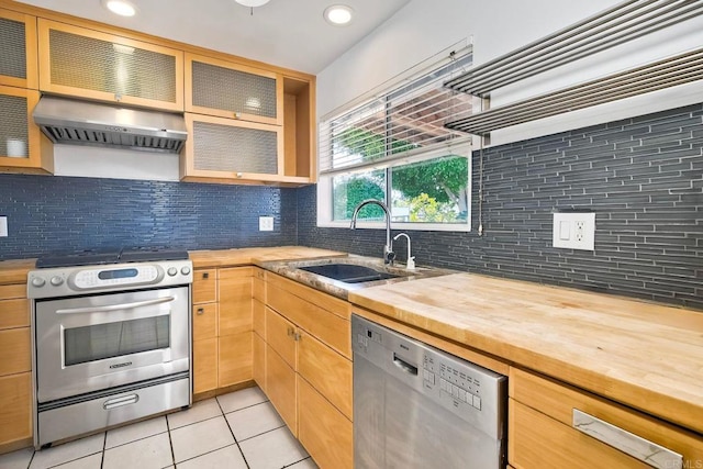 4549 Quailridge Dr, Oceanside, CA 92056 - kitchen featuring stainless steel appliances, wood counters, exhaust hood, light tile patterned floors, and recessed lighting