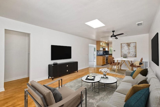 4549 Quailridge Dr, Oceanside, CA 92056 - living area featuring a skylight, light wood-style flooring, and a ceiling fan