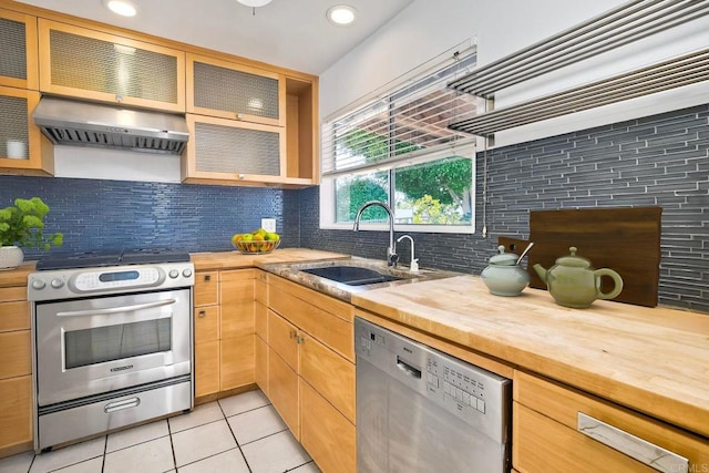 4549 Quailridge Dr, Oceanside, CA 92056 - kitchen featuring stainless steel appliances, wood counters, range hood, light tile patterned floors, and decorative backsplash