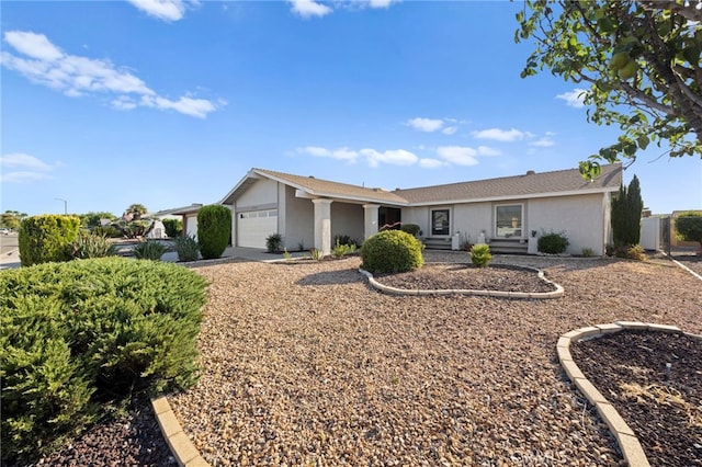 single story home featuring an attached garage, fence, and stucco siding