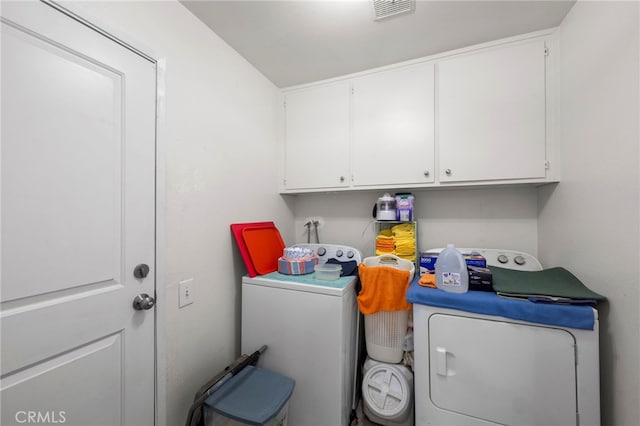 laundry room featuring independent washer and dryer, cabinet space, and visible vents