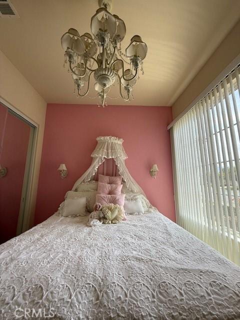 322 Brooklawn Dr, Banning, CA 92220 - bedroom with visible vents and an inviting chandelier