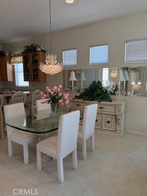 322 Brooklawn Dr, Banning, CA 92220 - dining space featuring a chandelier and light carpet