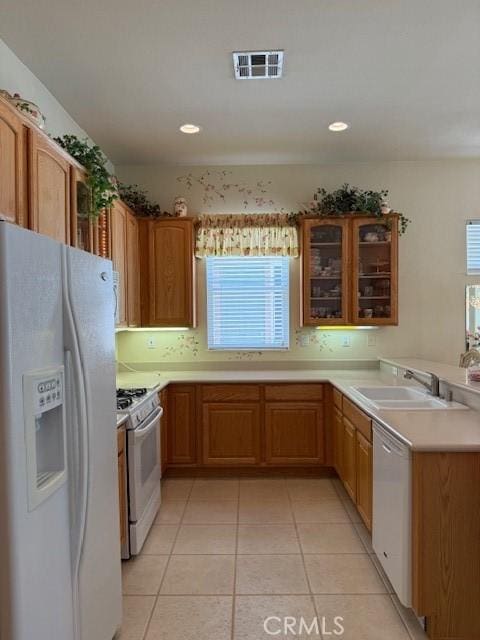 322 Brooklawn Dr, Banning, CA 92220 - kitchen featuring visible vents, a sink, a healthy amount of sunlight, and white appliances