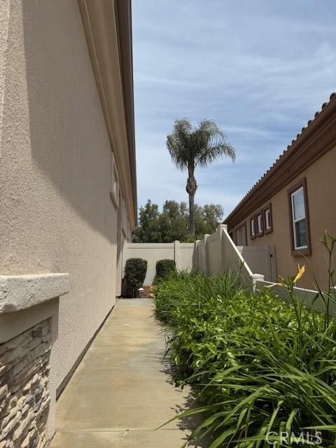 322 Brooklawn Dr, Banning, CA 92220 - view of home's exterior with fence and stucco siding