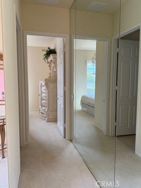 322 Brooklawn Dr, Banning, CA 92220 - hallway featuring light colored carpet and visible vents