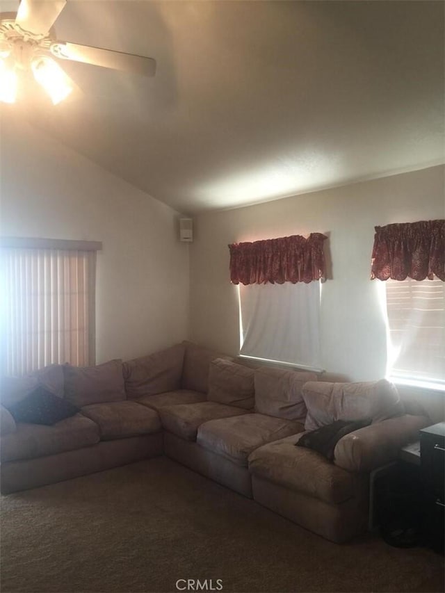 carpeted living room with a ceiling fan