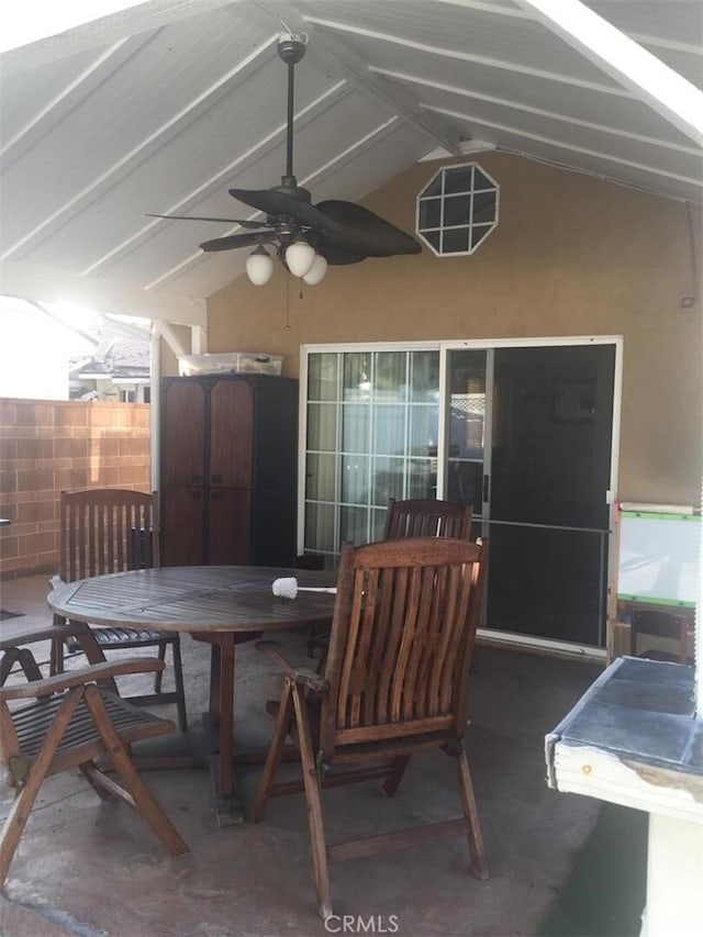 view of patio / terrace with outdoor dining area, fence, a shed, an outdoor structure, and ceiling fan