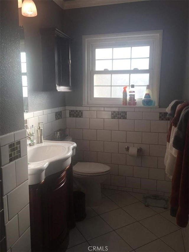 bathroom featuring vanity, tile walls, toilet, and tile patterned floors