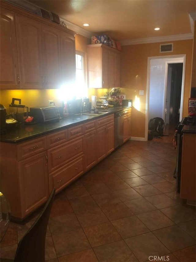 kitchen with ornamental molding, visible vents, stainless steel dishwasher, and dark countertops