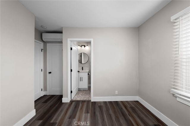 3204 Madison Ave, San Diego, CA 92116 - unfurnished bedroom with a wall mounted air conditioner, a sink, baseboards, dark wood-style floors, and ensuite bathroom