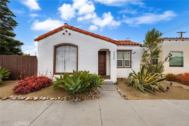 3204 Madison Ave, San Diego, CA 92116 - mediterranean / spanish house featuring a tiled roof, fence, and stucco siding