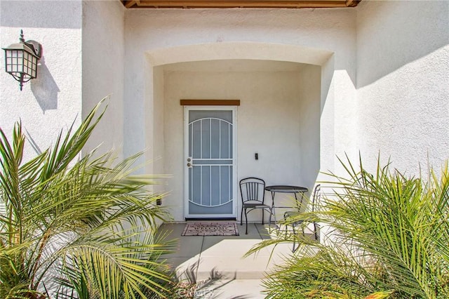 doorway to property with stucco siding