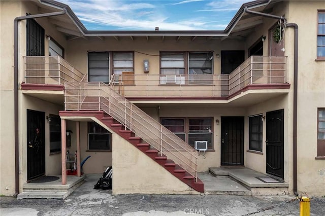 exterior space featuring stairs and stucco siding
