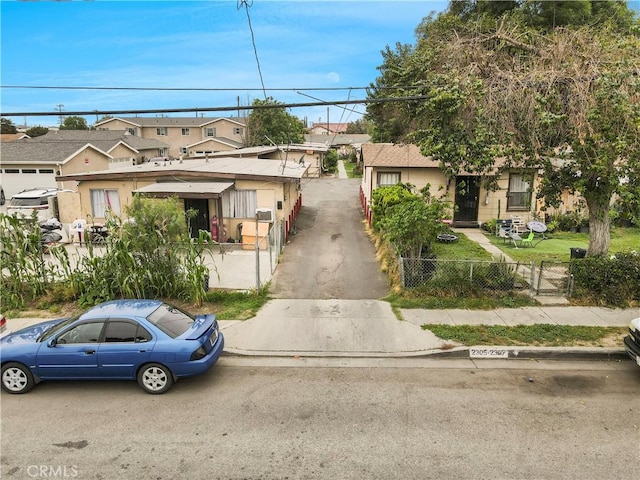 view of front of home featuring a gate, a fenced front yard, and a residential view