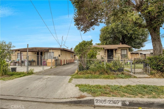 bungalow-style home featuring a gate and a fenced front yard