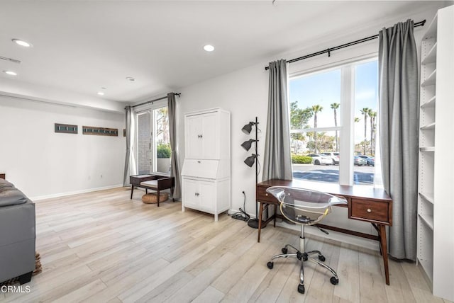 office area with light wood-type flooring, recessed lighting, and a wealth of natural light