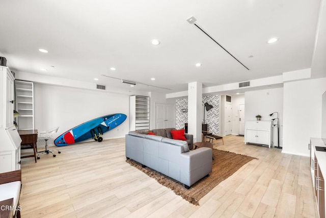 living area with recessed lighting, visible vents, and light wood-type flooring