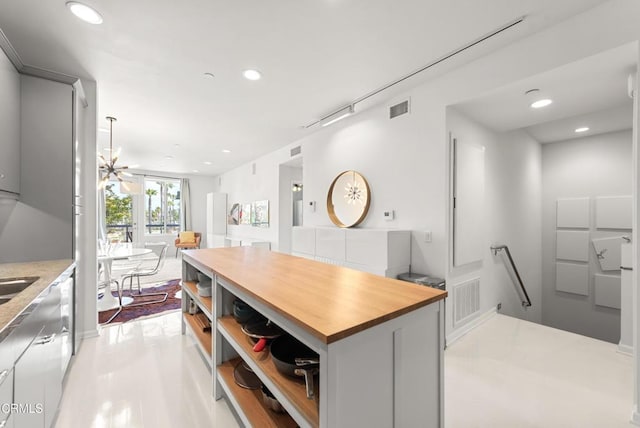 kitchen featuring recessed lighting, butcher block countertops, and visible vents
