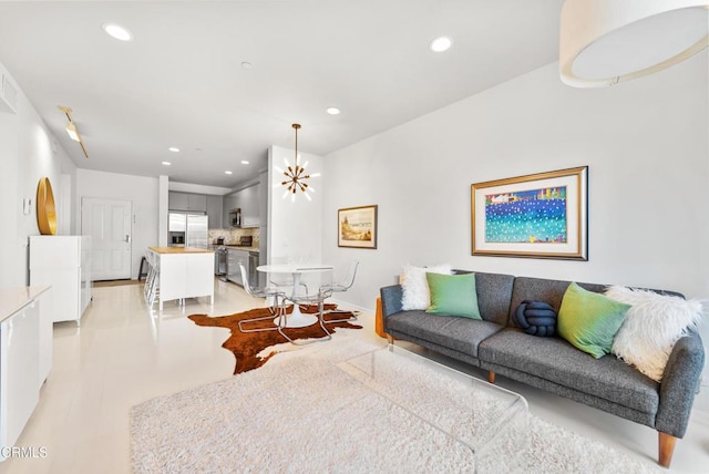 living room featuring baseboards and recessed lighting