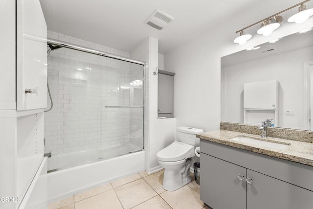 bathroom with toilet, visible vents, tile patterned flooring, and vanity