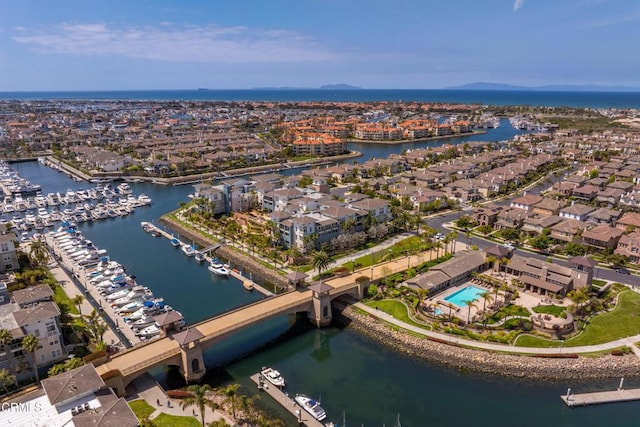 drone / aerial view featuring a water view and a residential view
