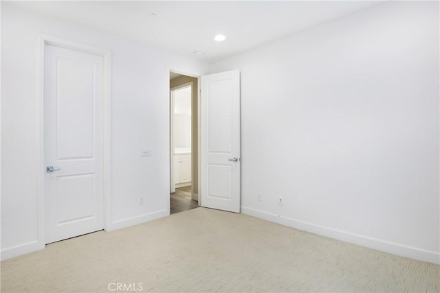 unfurnished bedroom with carpet floors, recessed lighting, and baseboards
