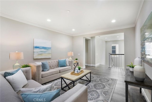 living area with recessed lighting, baseboards, ornamental molding, and wood finished floors