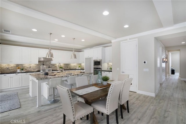 dining space with light wood-style floors, baseboards, recessed lighting, and visible vents