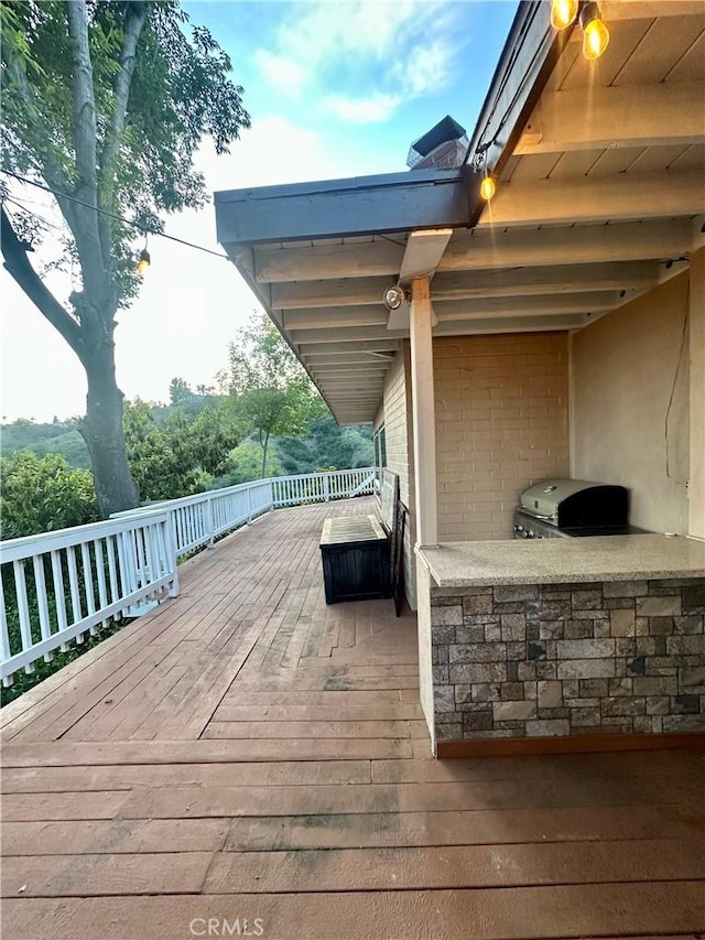 deck featuring grilling area and exterior kitchen