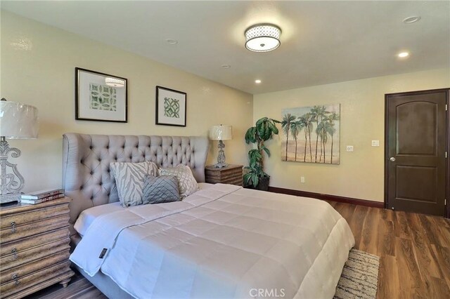 bedroom with recessed lighting, baseboards, and wood finished floors