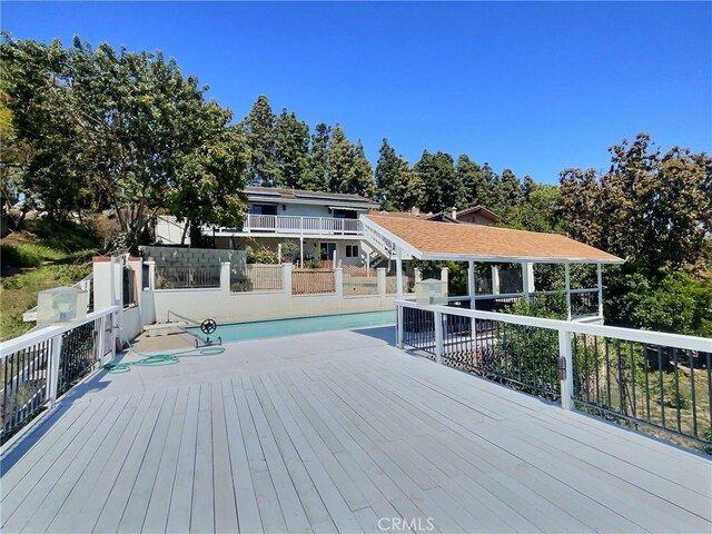 wooden deck with an outdoor pool