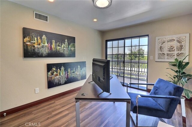 office featuring baseboards, recessed lighting, wood finished floors, and visible vents