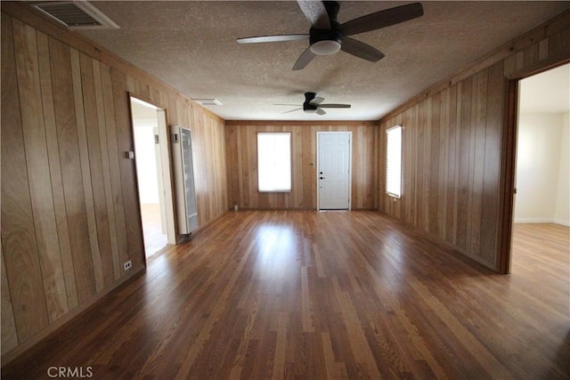 200 E St, Taft, CA 93268 - interior space featuring wood walls, a textured ceiling, ceiling fan, and wood finished floors
