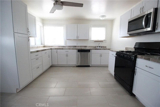 200 E St, Taft, CA 93268 - kitchen featuring a sink, white cabinetry, ceiling fan, and stainless steel appliances