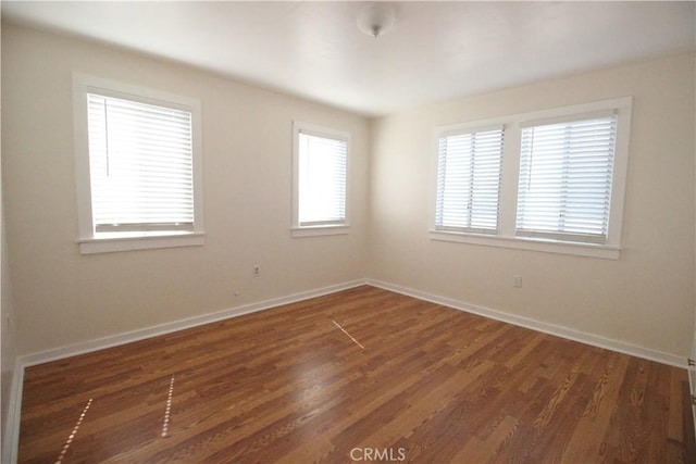 200 E St, Taft, CA 93268 - spare room featuring baseboards and wood finished floors