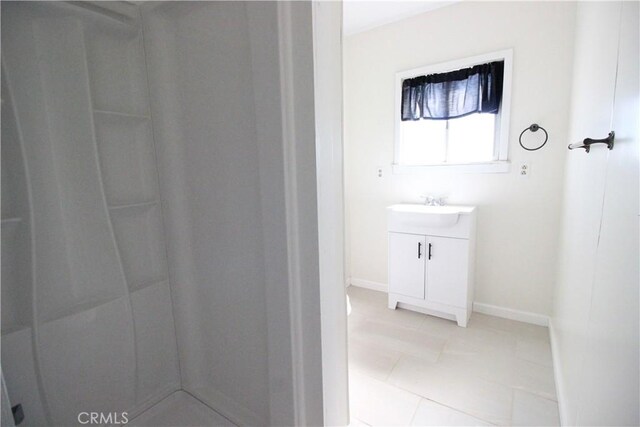 200 E St, Taft, CA 93268 - bathroom with baseboards, a shower, tile patterned flooring, and vanity
