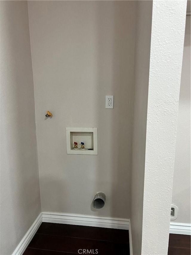 laundry area featuring baseboards, laundry area, and hookup for a washing machine