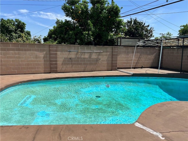 view of swimming pool featuring fence and a fenced in pool