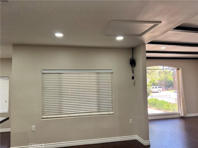 interior space featuring dark wood finished floors, baseboards, attic access, and recessed lighting