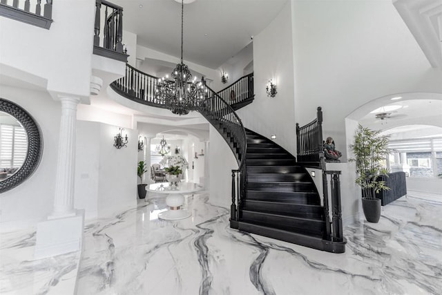 733 Clayburn Ct, Alpine, CA 91901 - foyer entrance with a high ceiling, arched walkways, marble finish floor, ceiling fan with notable chandelier, and stairs