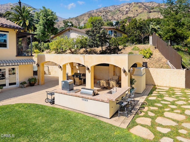 574 Camillo Rd, Sierra Madre, CA 91024 - back of property with an outdoor living space, a patio area, stucco siding, and a mountain view