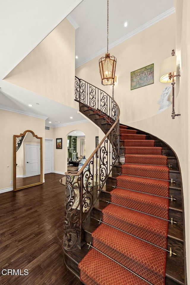 574 Camillo Rd, Sierra Madre, CA 91024 - staircase featuring arched walkways, recessed lighting, baseboards, wood finished floors, and ornamental molding