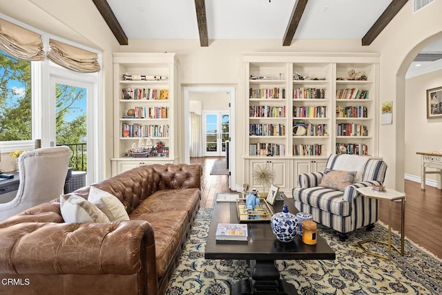 574 Camillo Rd, Sierra Madre, CA 91024 - living area with visible vents, arched walkways, built in shelves, wood finished floors, and beamed ceiling