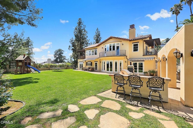 574 Camillo Rd, Sierra Madre, CA 91024 - back of house featuring a balcony, outdoor dry bar, a chimney, a patio area, and a yard