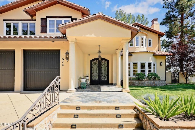 574 Camillo Rd, Sierra Madre, CA 91024 - entrance to property with covered porch, stucco siding, a chimney, and a tiled roof