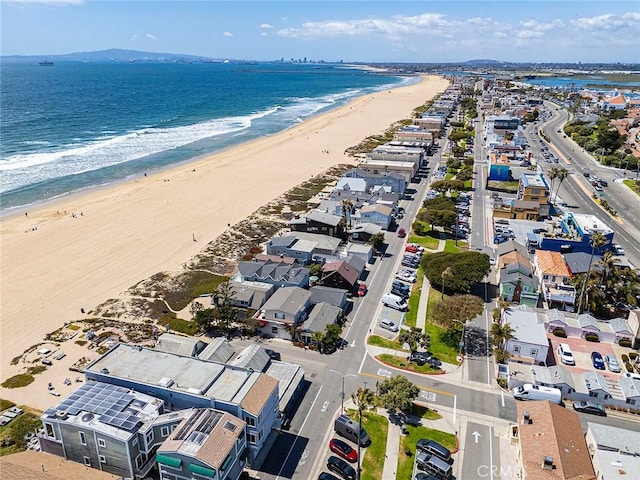 birds eye view of property featuring a water view and a view of the beach