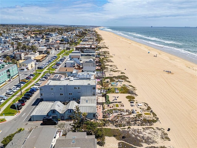 birds eye view of property with a view of the beach and a water view