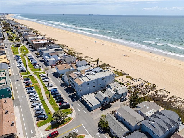 drone / aerial view with a water view and a beach view